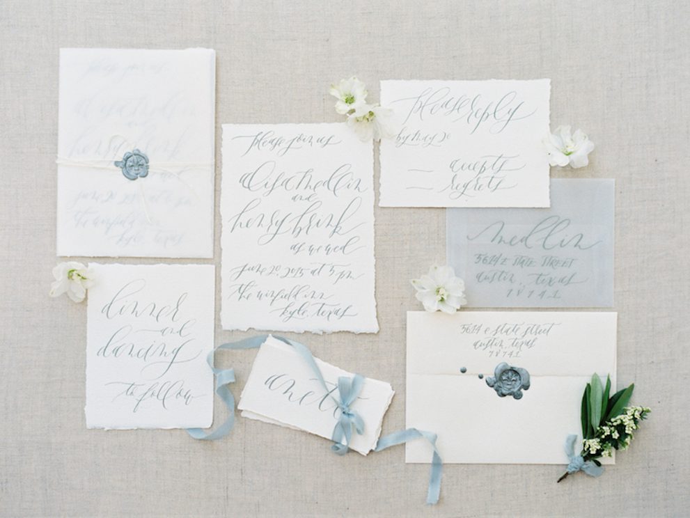 Wedding invitation written in blue ink.